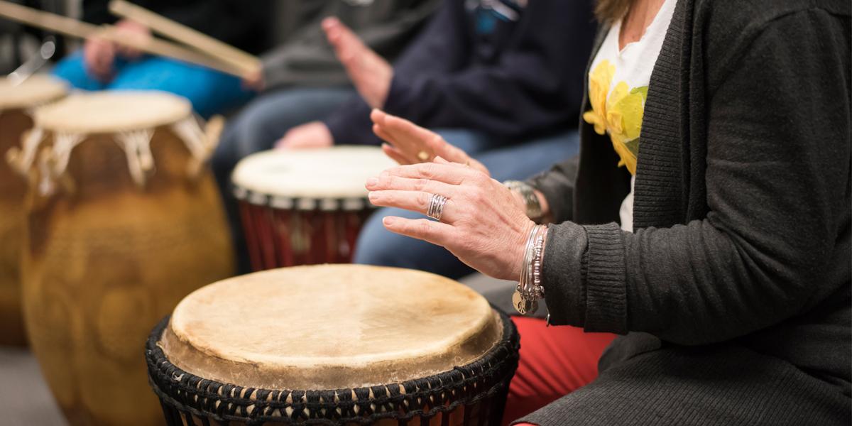 AACC students play percussion instruments in a classroom.